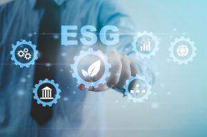 Environmental, social, and governance (ESG) investment Organizational growth that is sustainable is a business idea. A man's hand touches the ESG word on a virtual screen.